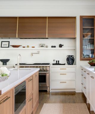 fawn brown and white kitchen with upper wood cabinets and lower in wood, white cabinets, hardwood floor, white countertops, op