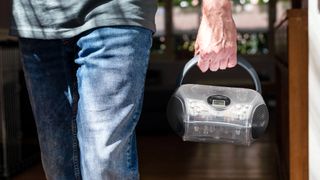 Man carrying a Lenco SCD-24TR CD player