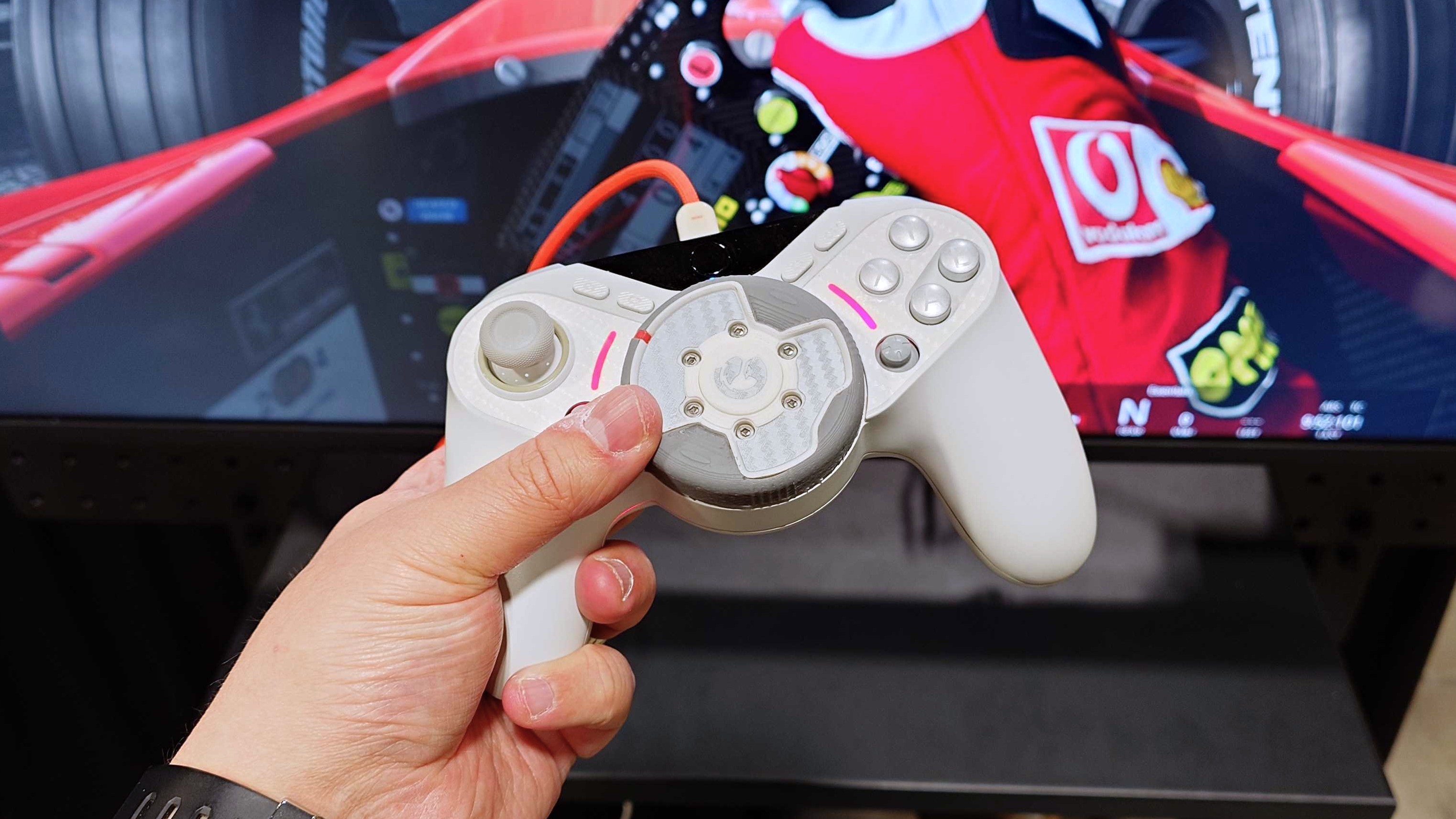 A photo of a prototype GameSir Swift Drive controller steering a race car in Assetto Corsa.