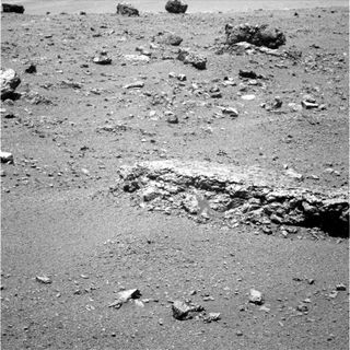 The flat-topped rock just below the center of this raw image from the rover Opportunity's panoramic camera was chosen by the rover team in August 2011 as a stop for inspecting with tools on Opportunity's robotic arm. This image was taken during the 2,688th Martian day, or sol, of Opportunity's work on Mars (Aug. 16, 2011), which was seven days after the rover arrived at the western rim of Endeavour Crater. The rock, informally named "Tisdale 2," displays a different texture than rocks that Opportunity has seen during the rovers' first 90 months on Mars.