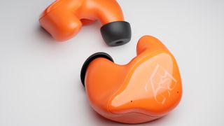 BREGGZ custom earbuds in orange, on a white background