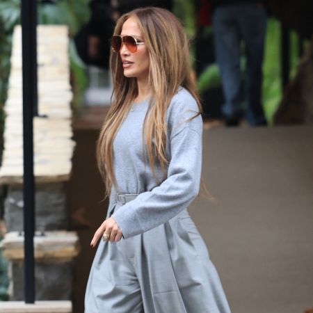 Jennifer Lopez wears gray wide-leg pants with platform heels
