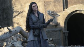 Alys Rivers stands in Harrenhal's Godswood with an owl on her left forearm in House of the Dragon season 2 episode 6