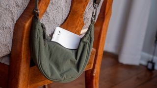 A white Onyx Boox Palma 2 in a small green purse