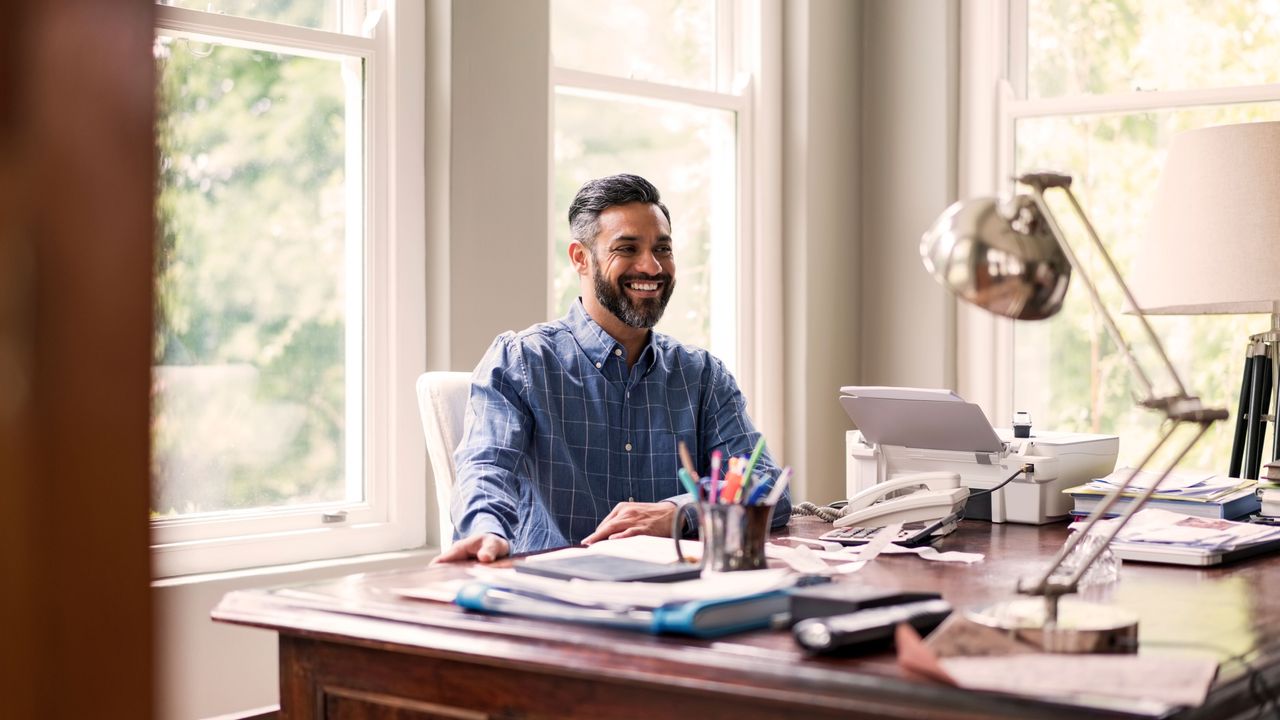 best colour printer: man sat in home office