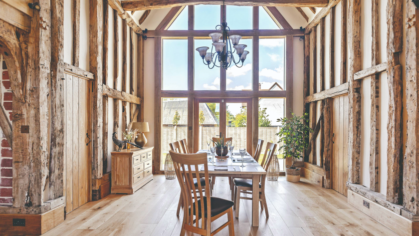 Living area in a barn conversion with large windows and overhead lighting