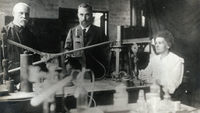 Marie and Pierre Curie (center and right) in their lab with another unidentified man.