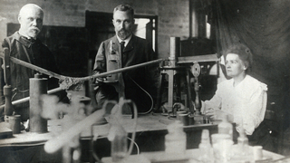 Marie and Pierre Curie (center and right) in their lab with another unidentified man.