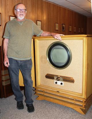 Early Television Museum founder Steve McVoy poses with a recent acquisition by the museum, this “super rare” 1953 Raytheon color television receiver. According to McVoy only three such sets are known to exist.