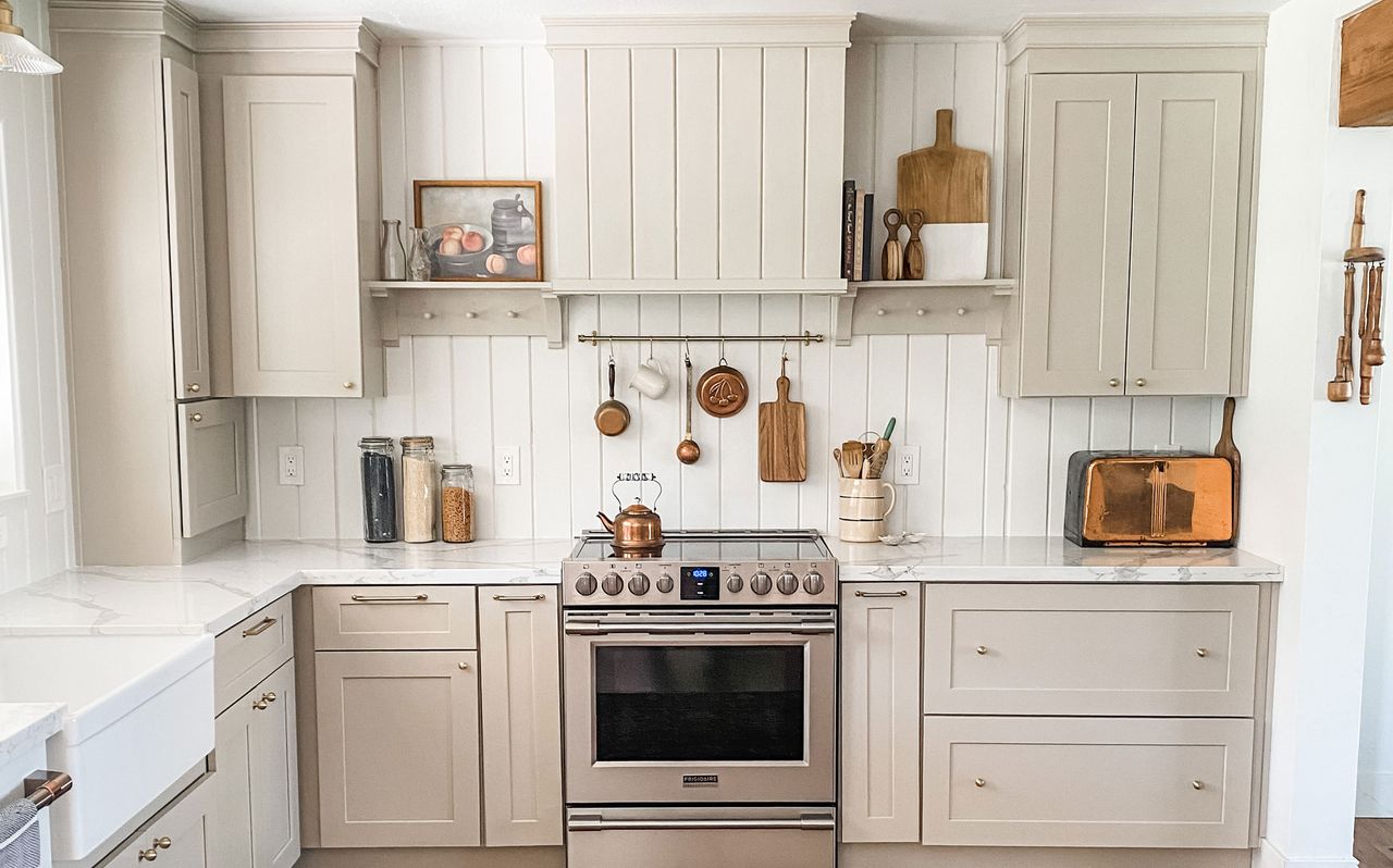 White cooker range in farmhouse kitchen with pots and pans hanging on the wall