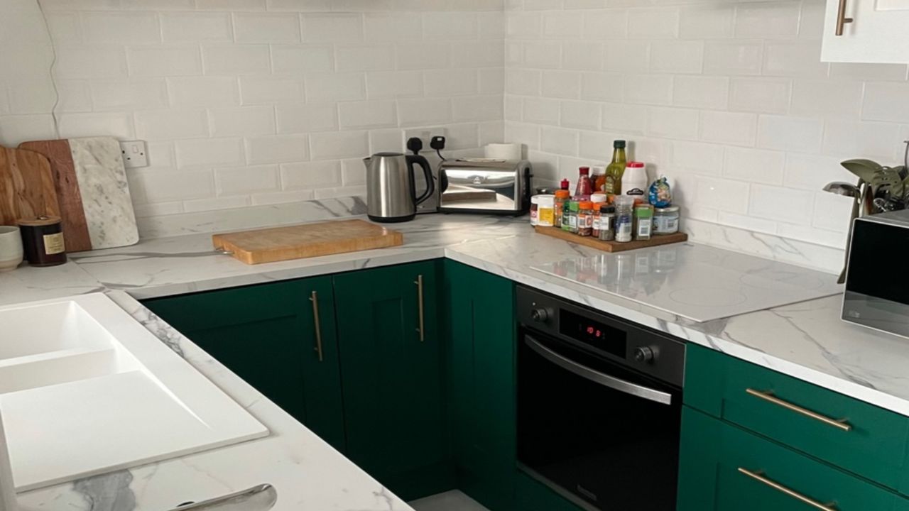 green kitchen with marble worktops