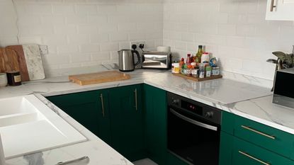 Small kitchen with green cabinets and a marble worktop