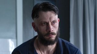 Ruben sitting on the edge of a hospital bed in Half Man