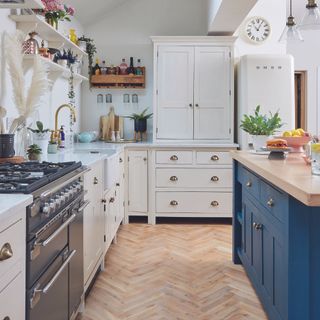 Kitchen with wooden worktop on island and quartz on side cabinets.