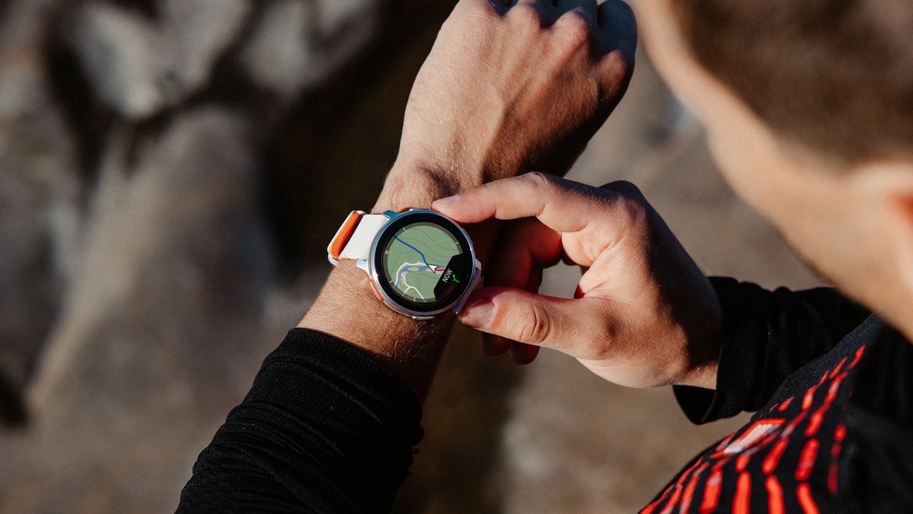 best polar watch: athletes checking the map on a Polar Vantage V3