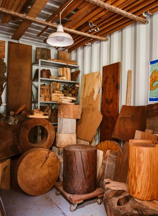 Interior of Ido Yoshimoto's workshop in Inverness, California, with stacks of wooden elements from his production