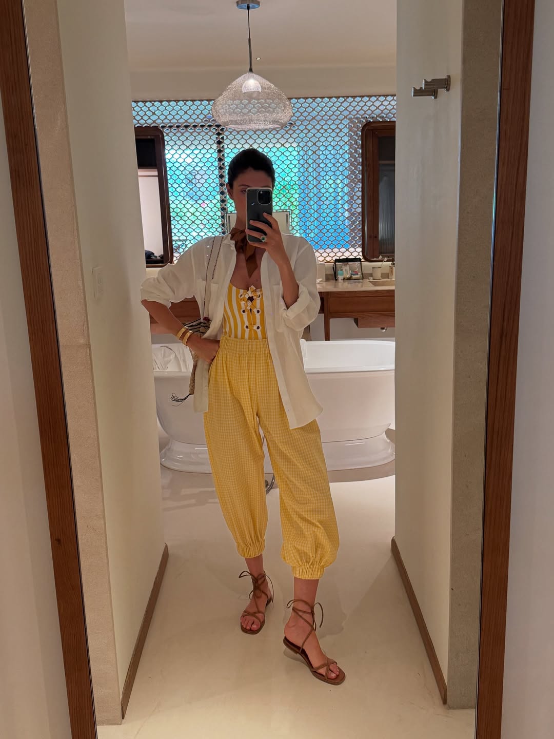 @mariadelaord wears yellow ballon trousers, yellow striped swimsuit and white shirt