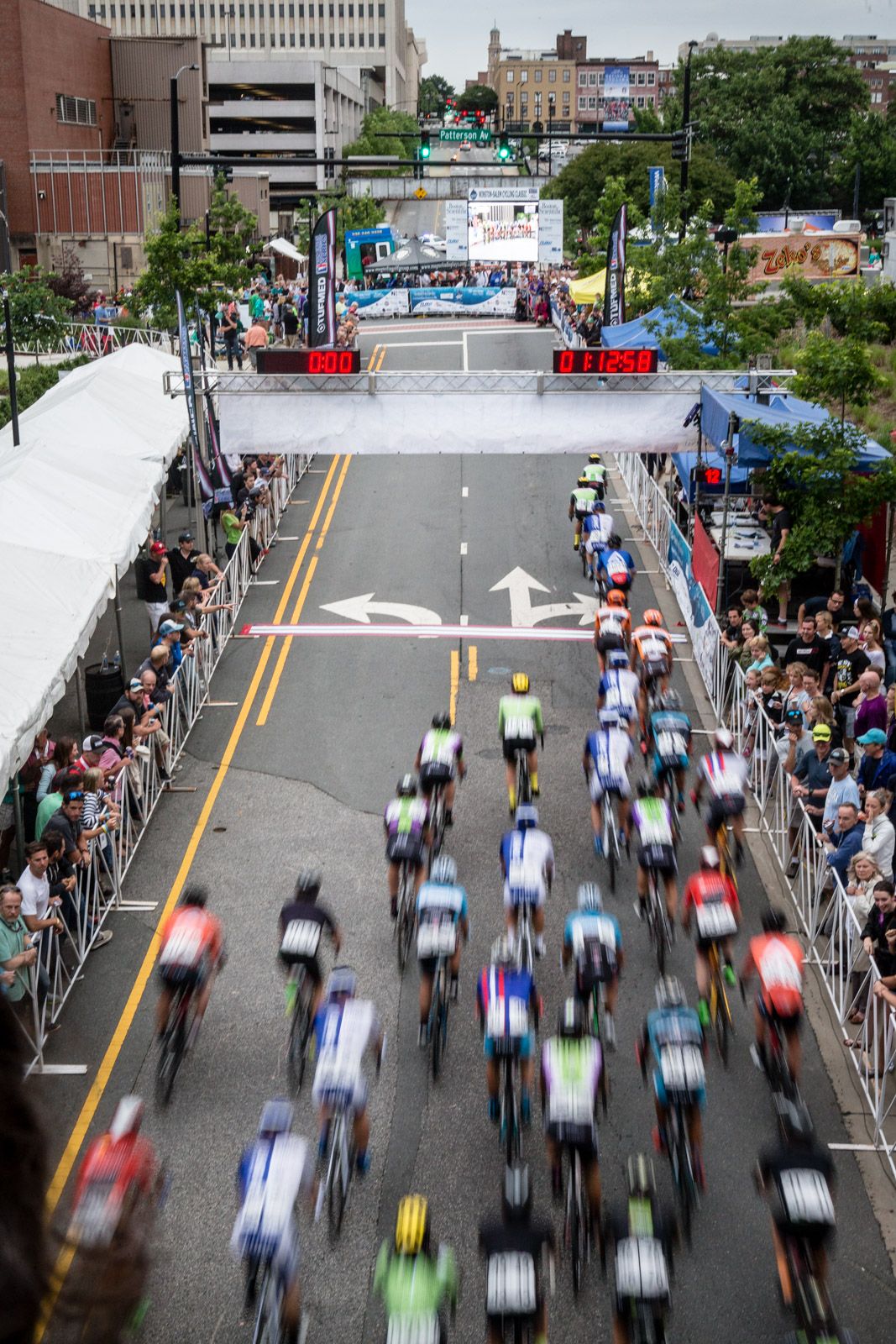 The peloton passes through the start/finish area.