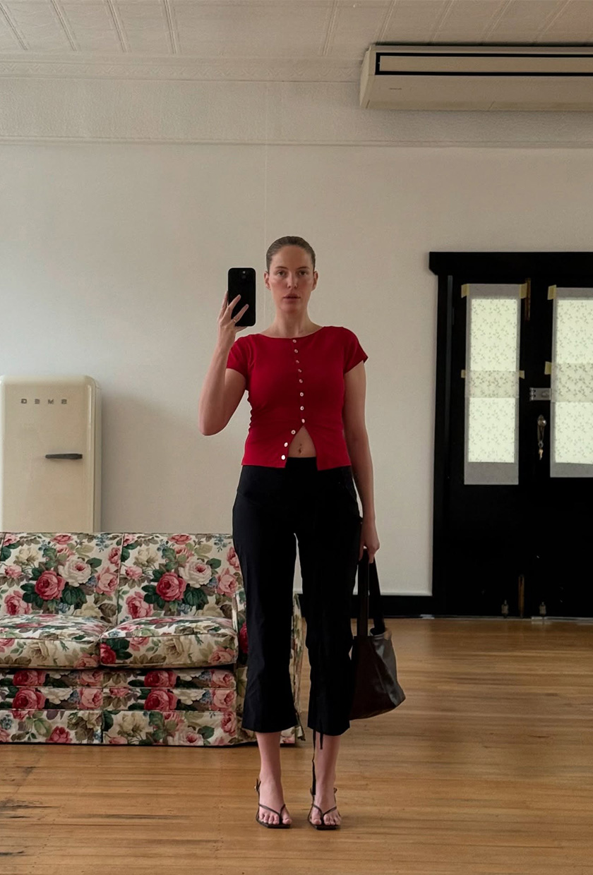 Ailie Smith wearing a red top with black capris.