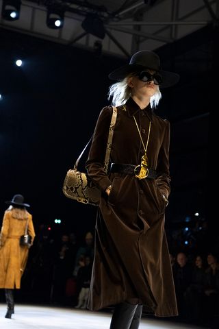 A model with an animal print sling bag
