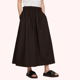 Flat lay cropped image of woman wearing brown long skirt