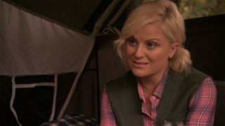 Leslie Knope (Amy Poehler) camping in a tent in Parks and Recreation