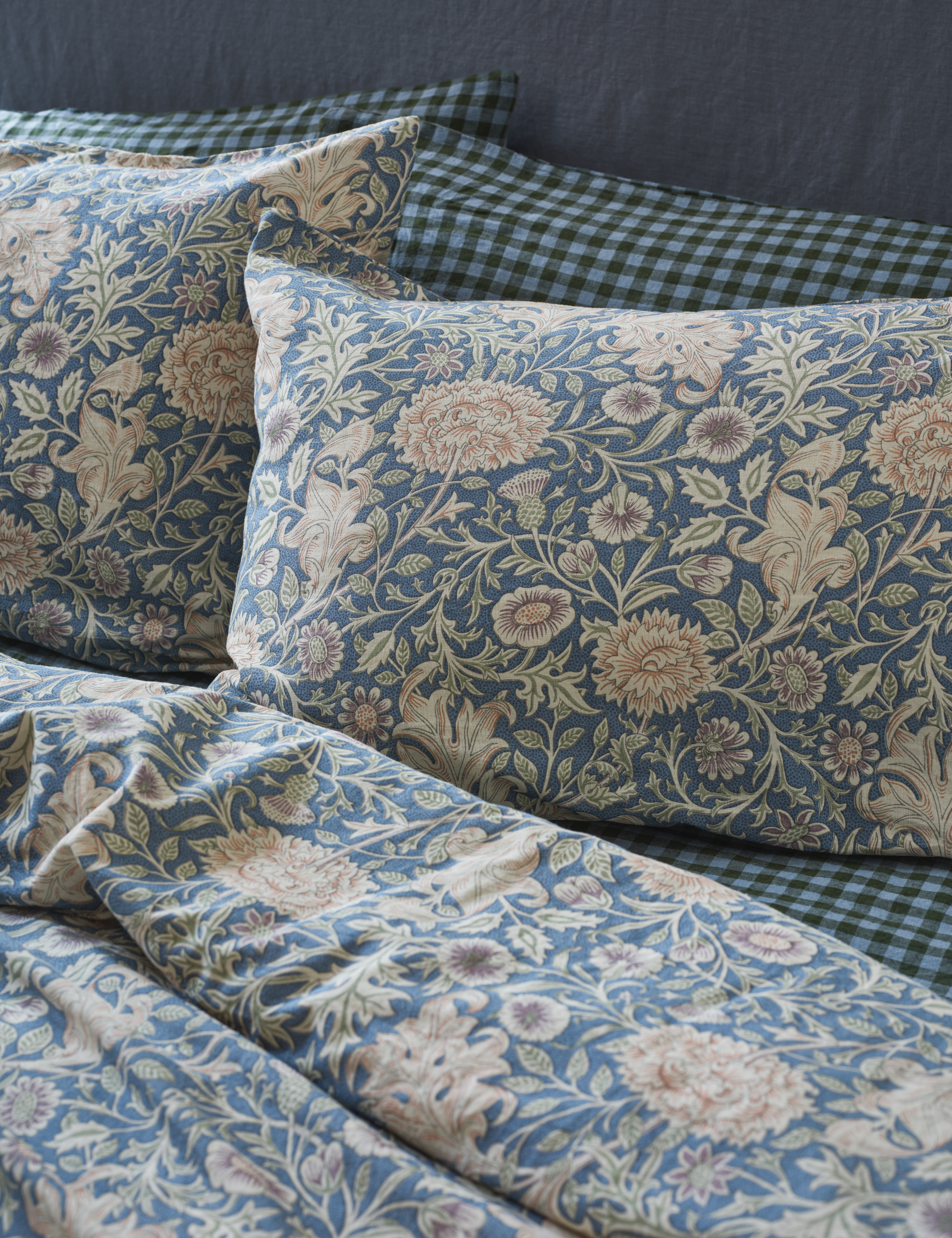 Piglet in Bed x Morris &amp;amp; Co. sheets in blue gingham layered with a botanical print in a coordinating shade