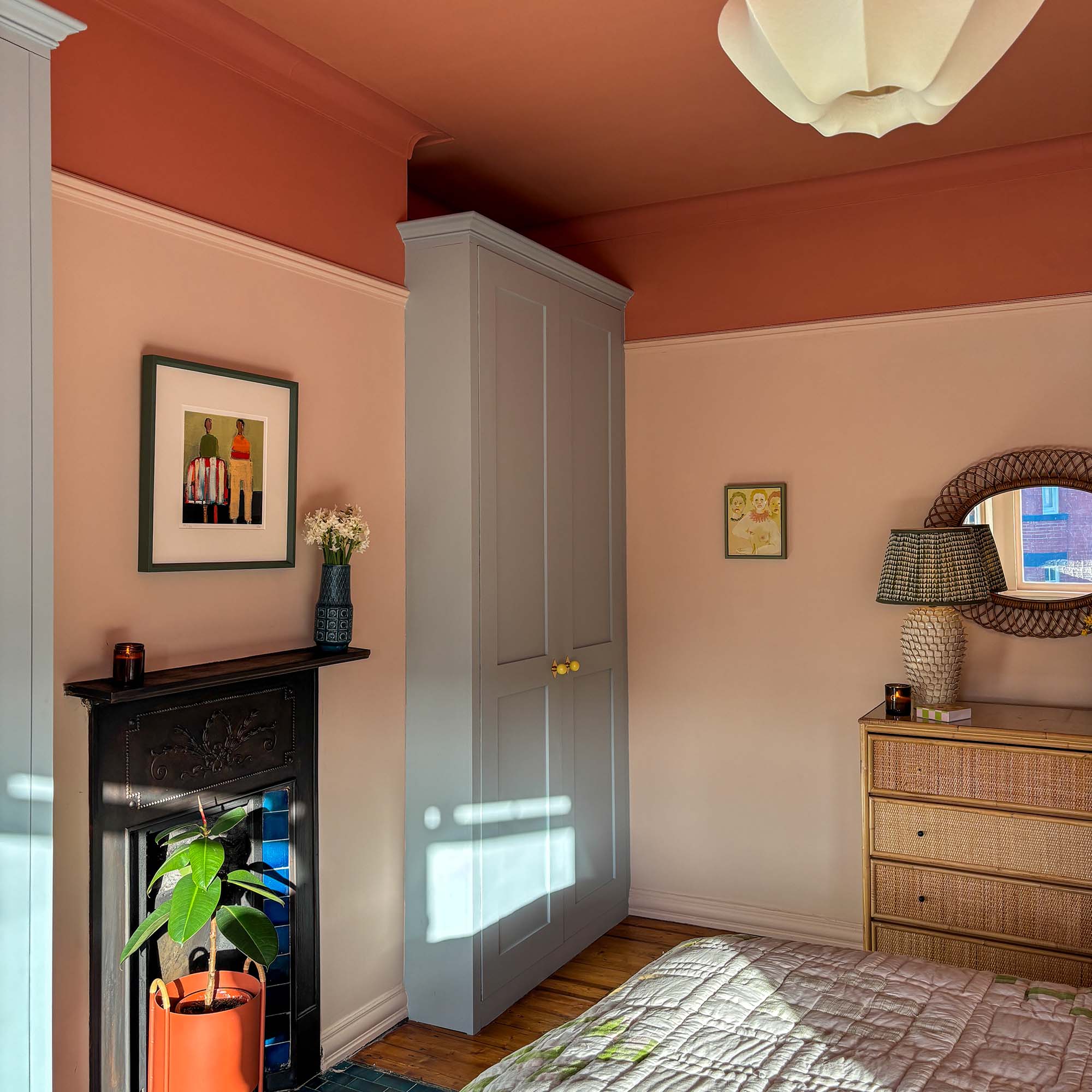 pink living room with prints framed on the walls