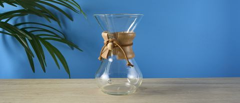 an hourglass coffee maker by Chemex with a 6 cup capacity and a wooden collar with a rawhide tie