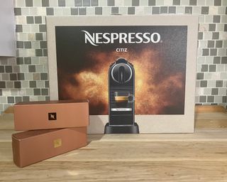 Nespresso Citiz outer packaging with two boxes of Nespresso pods on kitchen countertop