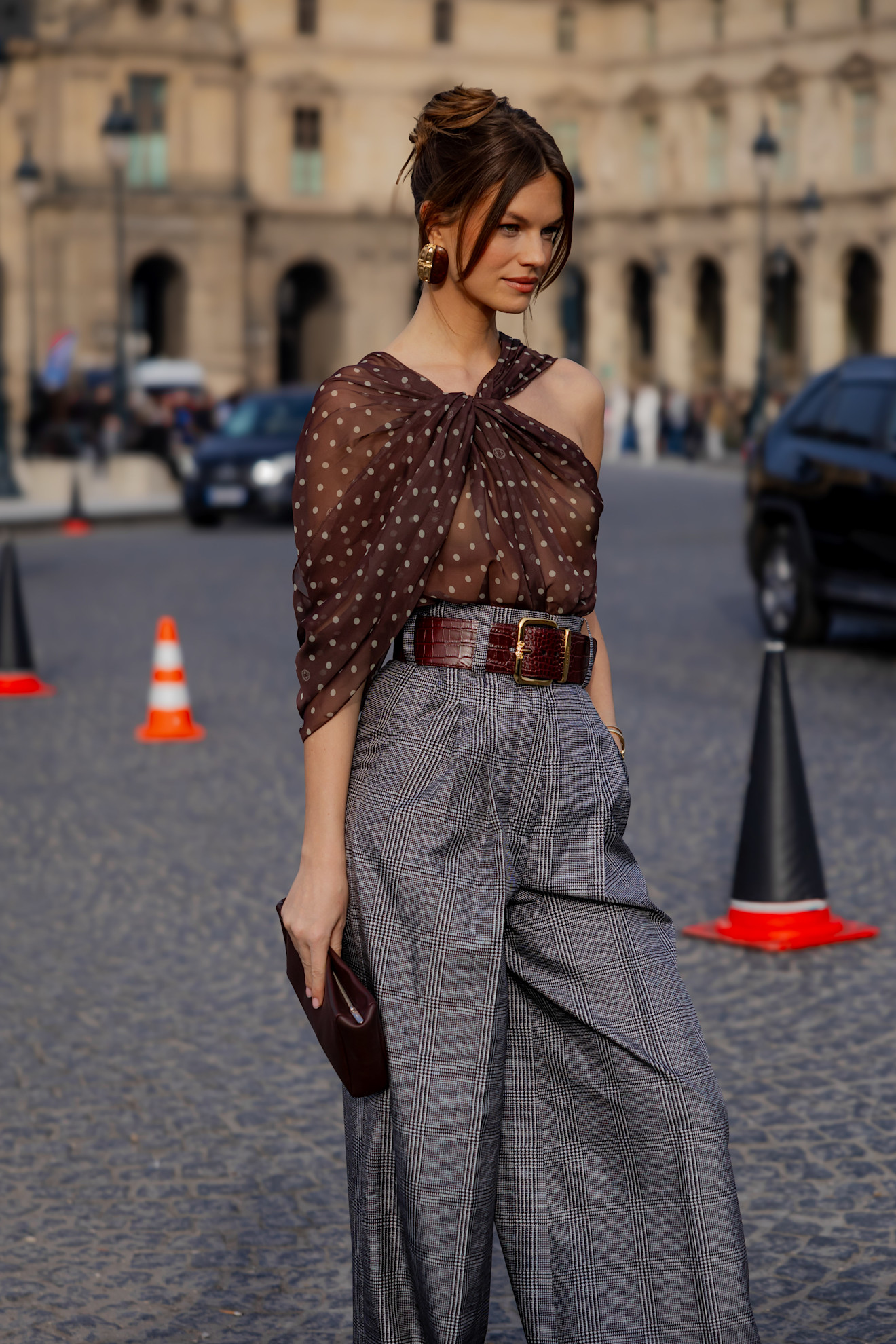 A woman wearing. aFrench twist hairstyle at Paris Fashion Week AW26