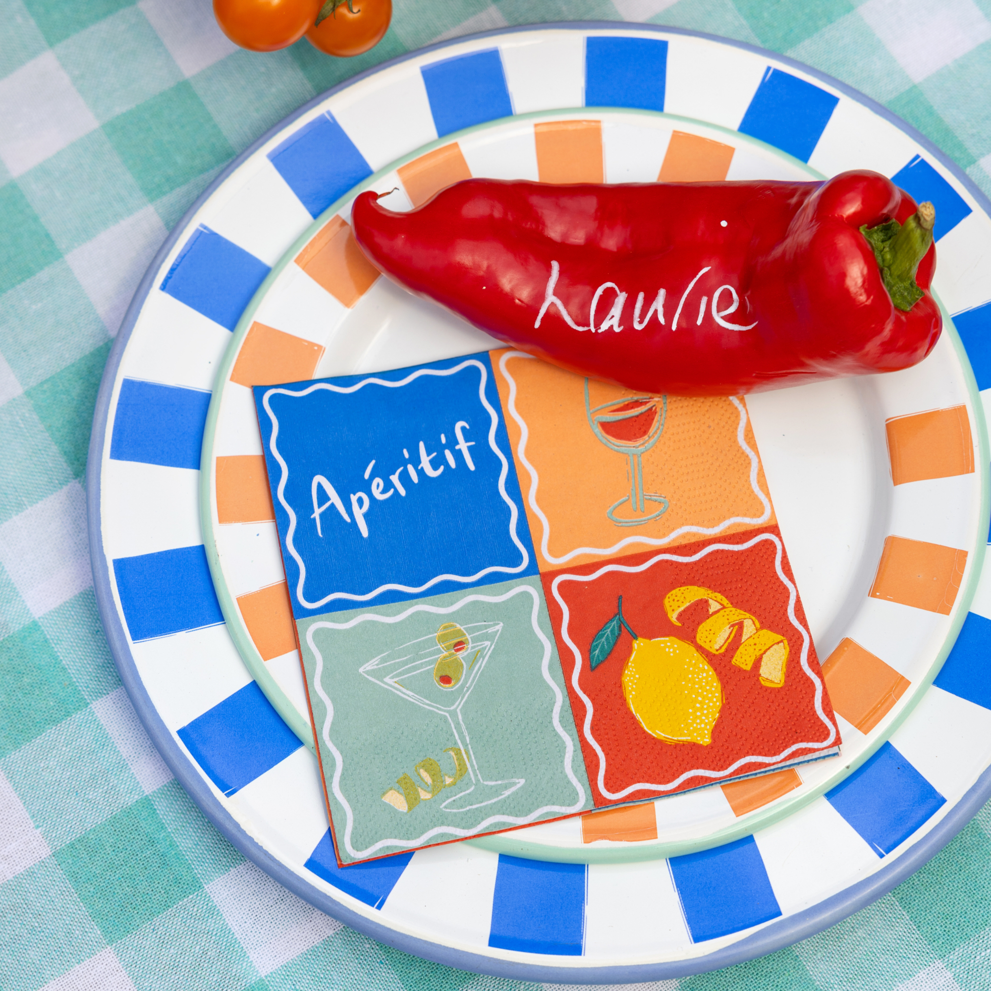 colourful table decor with plates, napkins and a personalised name tag