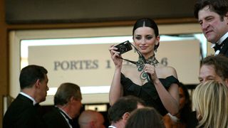 Actress Penelope Cruz snaps a picture during arrivals at the opening ceremony of the 56th International Cannes Film Festival at the Palais de Festival and the premiere of "FanFan La Tulipe" May 14, 2003 in Cannes, France.