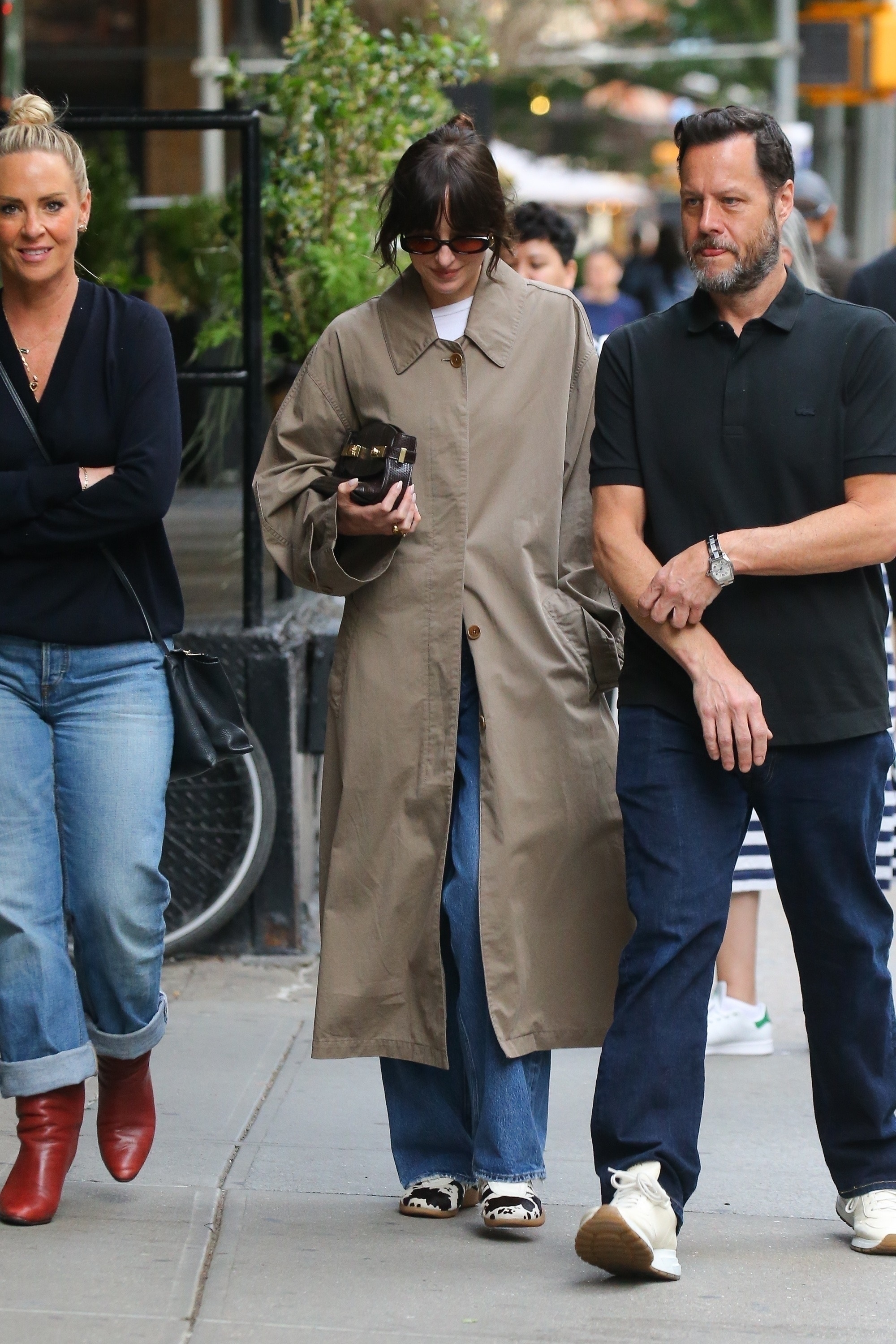 An image of Dakota Johnson wearing Adidas Taekwondo trainers, one of the best summer trainers.