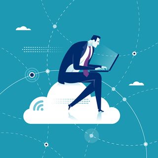 Businessman sits on a cloud while working on a laptop