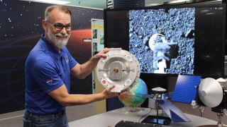 Ready and waiting. Dante Lauretta, OSIRIS-REx’s principal investigator from the University of Arizona holds a mock up of the asteroid collection device.