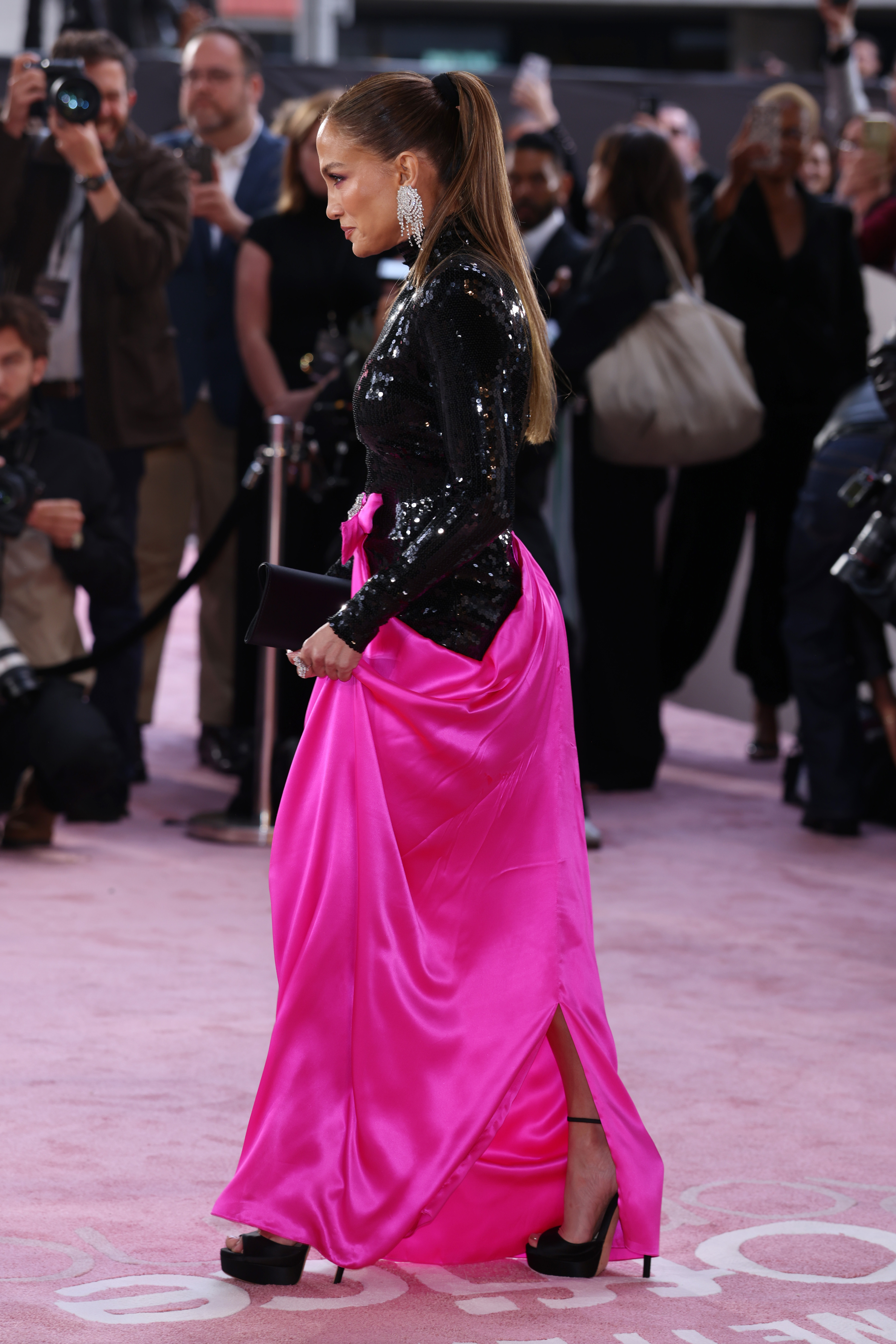 Jennifer Lopez wore a black sequin gown with a neon pink skirt at the Office Romance premiere in London
