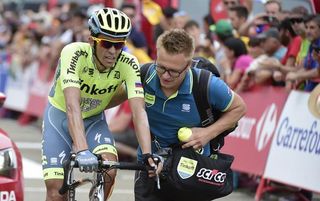 Alberto Contador (Tinkoff) being helped after crossing the finish line stage 15