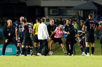 Multiple fans ran onto the pitch to try to get to Lionel Messi