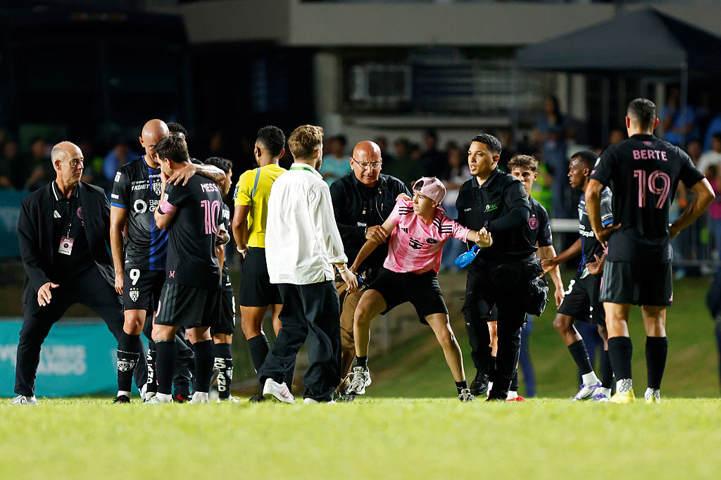 Multiple fans ran onto the pitch to try to get to Lionel Messi