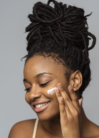 Woman applying skincare