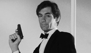 The Living Daylights Timothy Dalton poses casually with his gun in the air