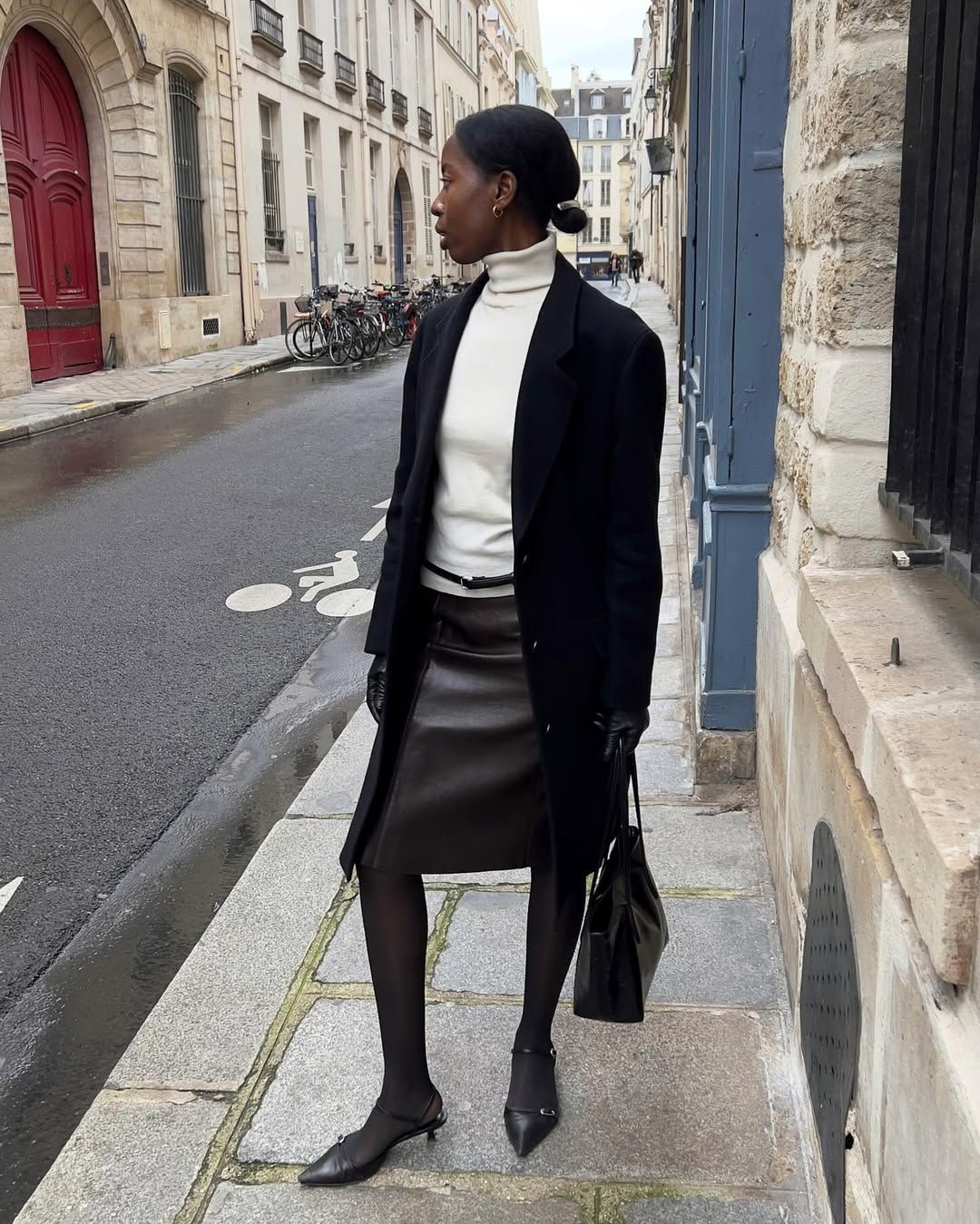 Sylvie in a turtleneck top and skirt