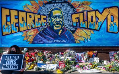 Flowers, signs and balloons are left near a makeshift memorial to George Floyd near the spot where he died while in custody of the Minneapolis police, on May 29, 2020 in Minneapolis, Minnesota.