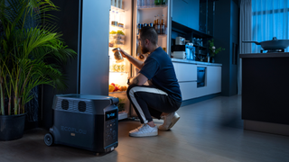 A man gets food out of a fridge working despite power outage