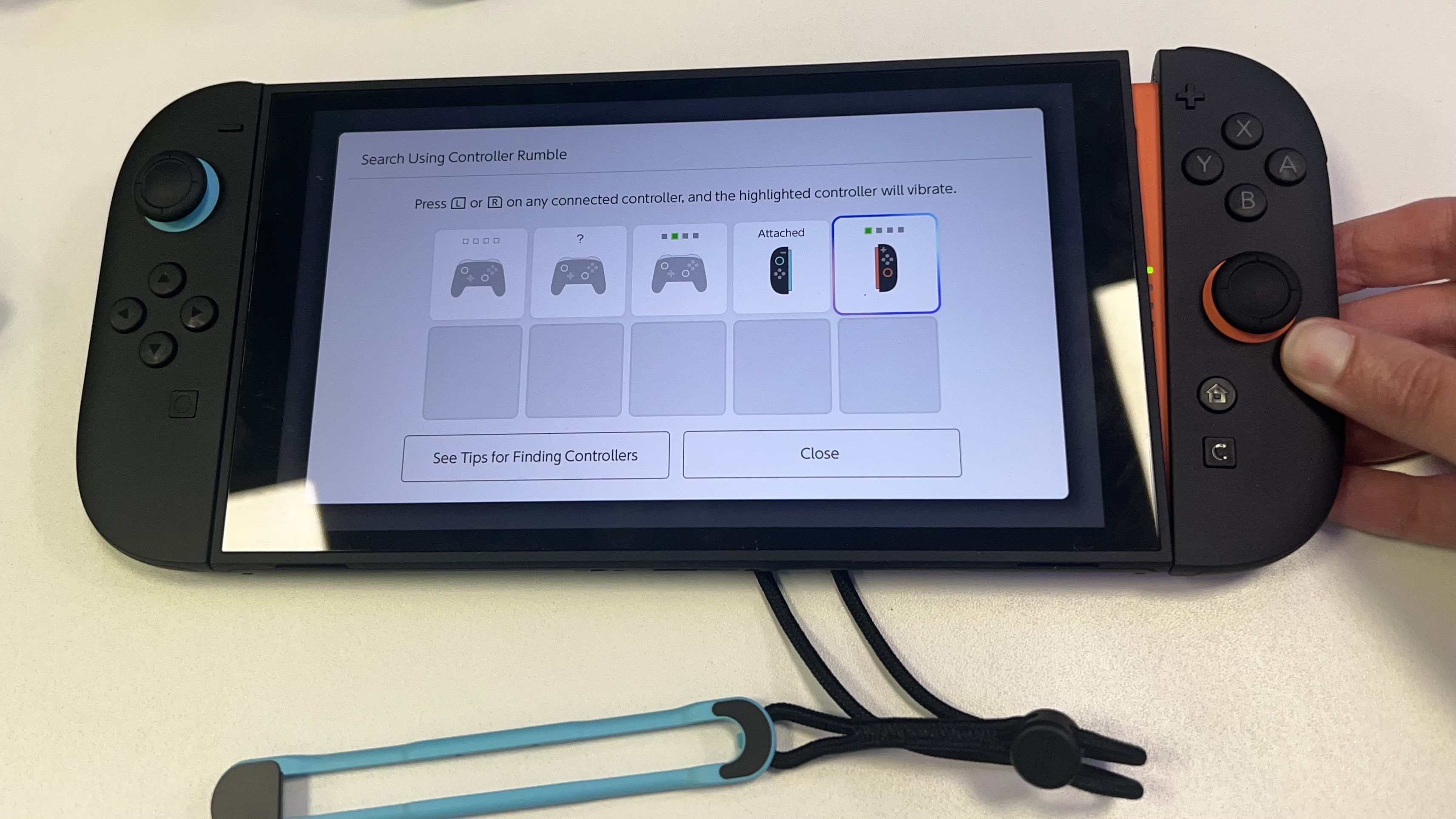 Nintendo Switch 2 with Joy-Con controller being removed from the side of the handheld