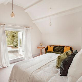 bedroom with white wall and white bed with window and curtains