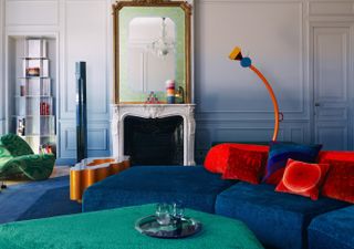 A living room drenched in blue, red and green tones