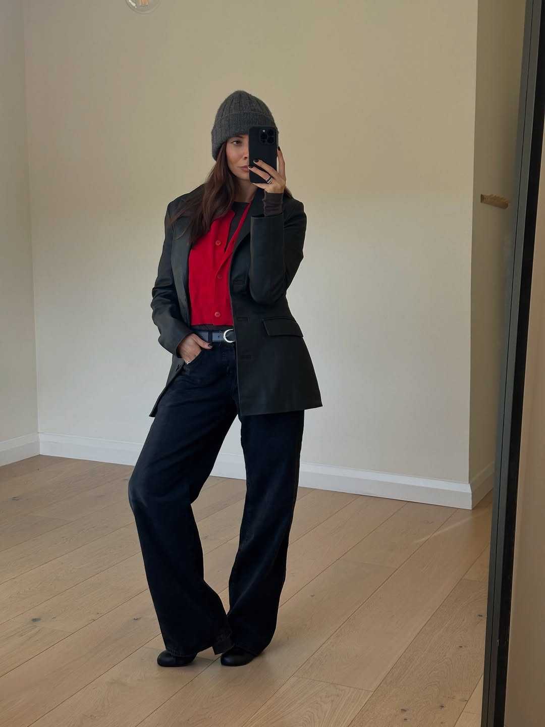 @smythsisters wearing bright red with black jeans