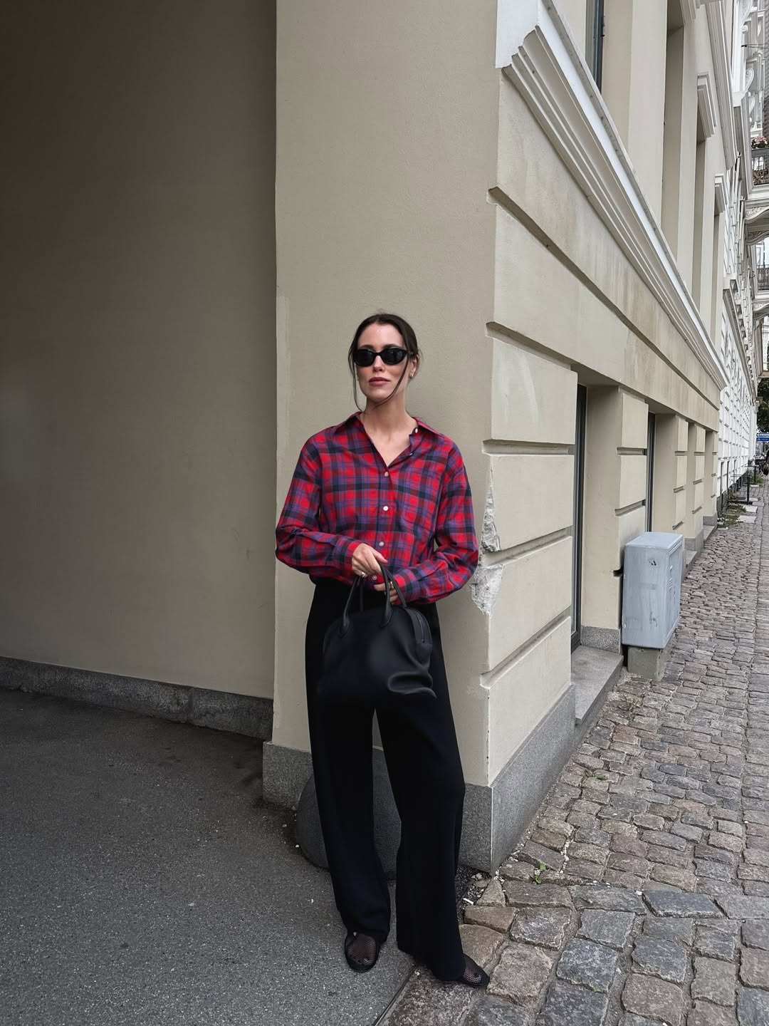 @annabelrosendahl wears red flannel shirt black trousers